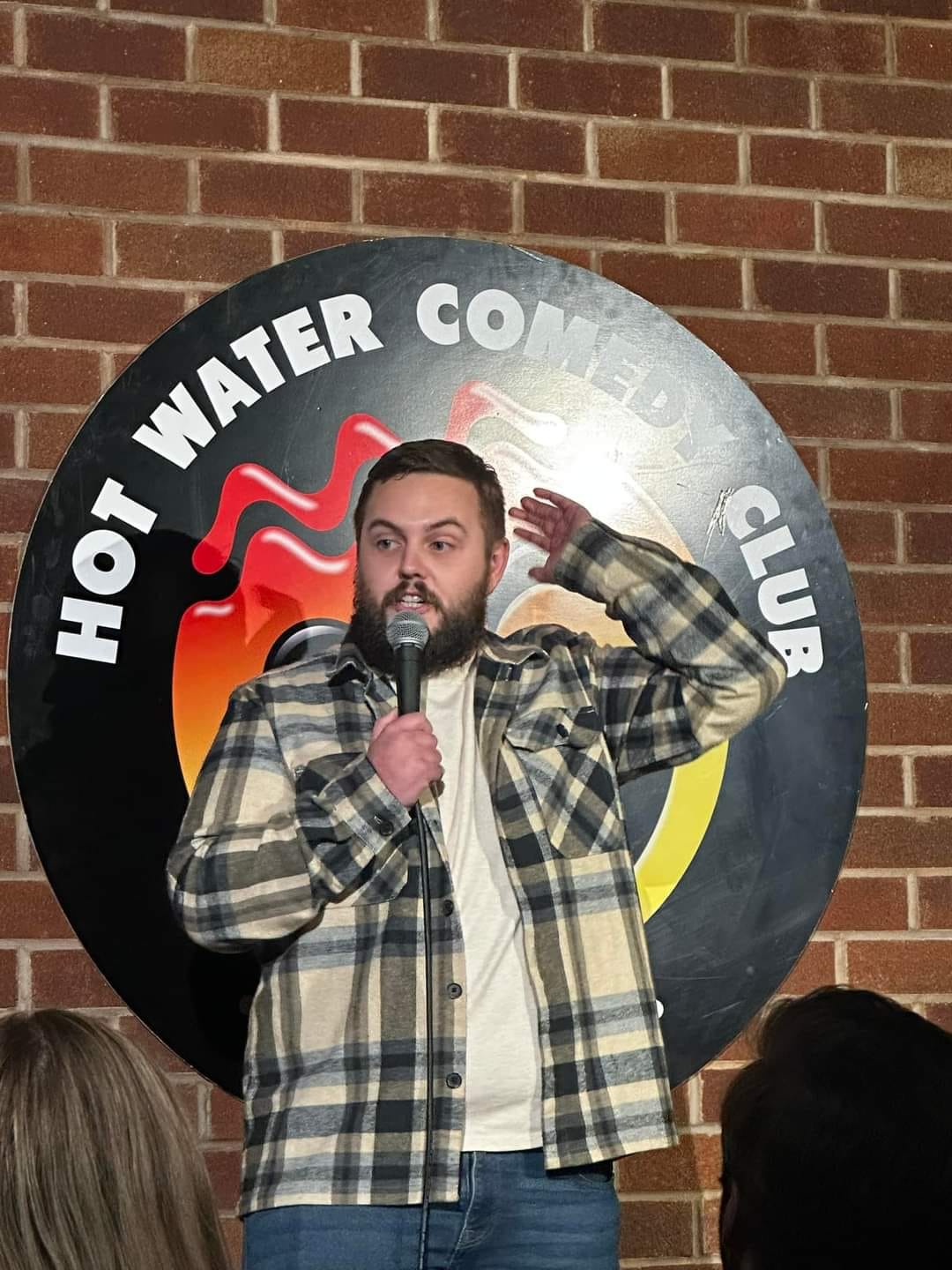 Jamie mid-gesture at the Hot Water Comedy Club